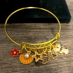 Gold Bangle with red flower and Orange clam.